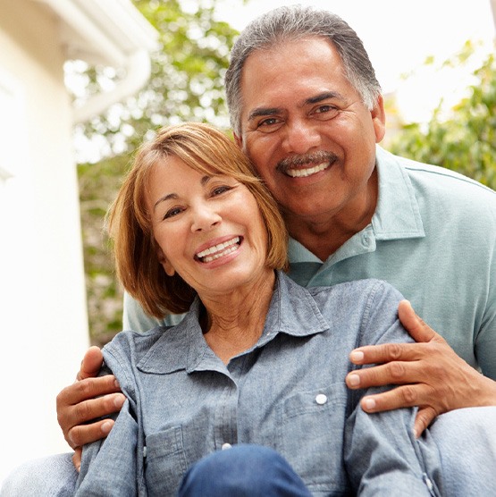 Patient in Phoenix smiling confidently with partner after getting dentures
