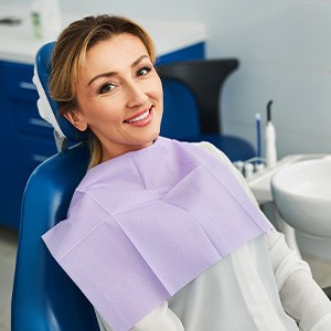 Woman smiling while sitting in treatment chair