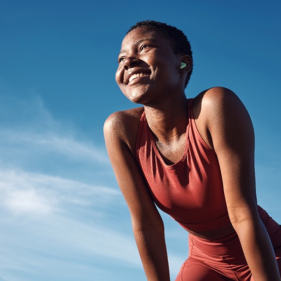 Lady smiles triumphantly outdoors
