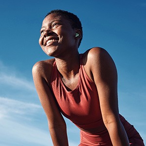 Woman smiling while exercising outside