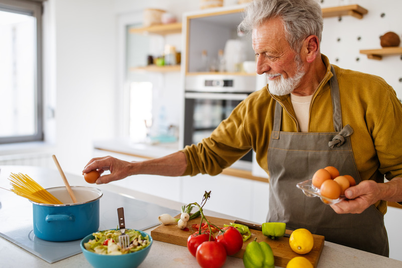 Dentures patient preparing healthy food