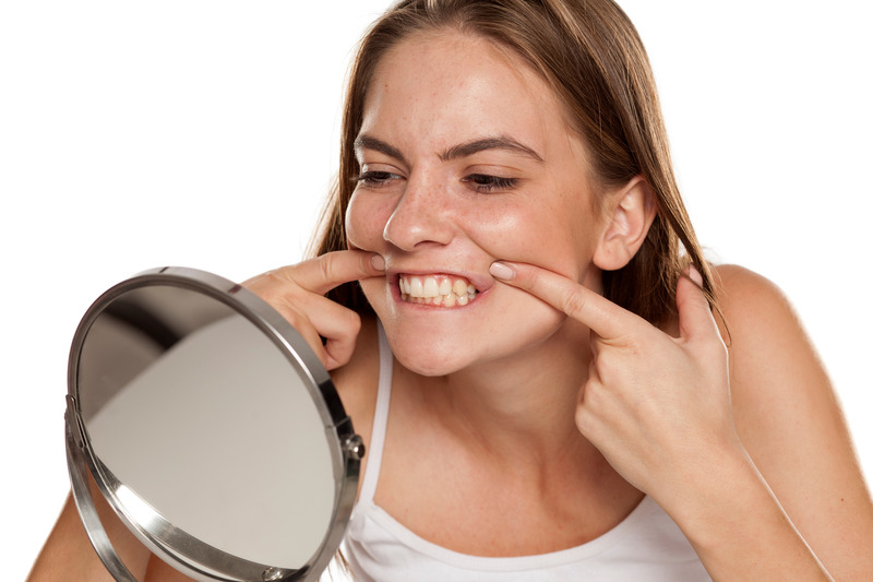 Patient checking their veneers in mirror